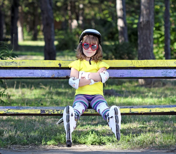 Маленькая девочка со шлемом и роликами — стоковое фото
