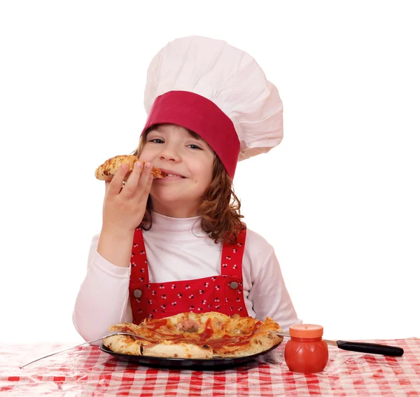 Hungry little girl cook eat pizza — Stock Photo, Image