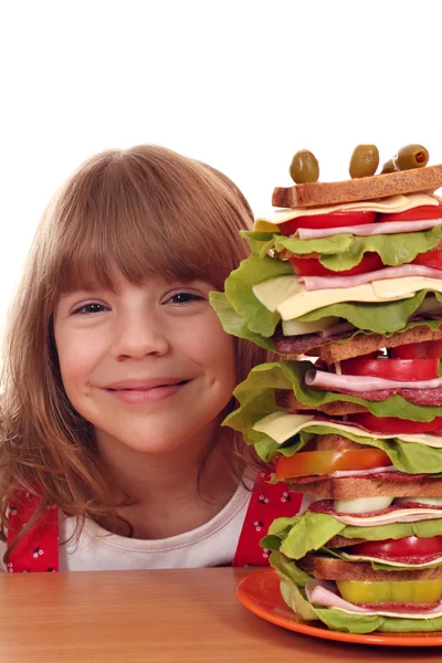 Beautiful happy little girl with tall sandwich — Stock Photo, Image