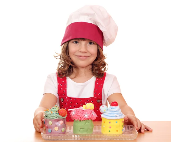 Beautiful little girl cook with cupcakes — Stock Photo, Image