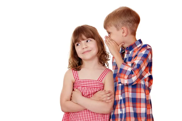 Boy whispering a secret little girl on white — Stock Photo, Image