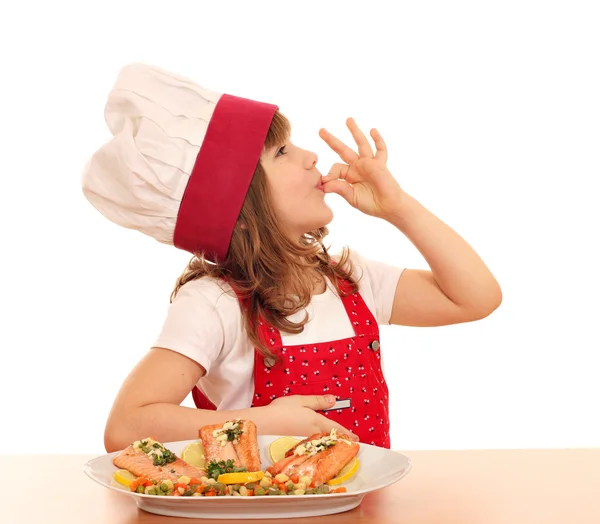 Little girl cook with ok hand sign and salmon on dish — Stock Photo, Image