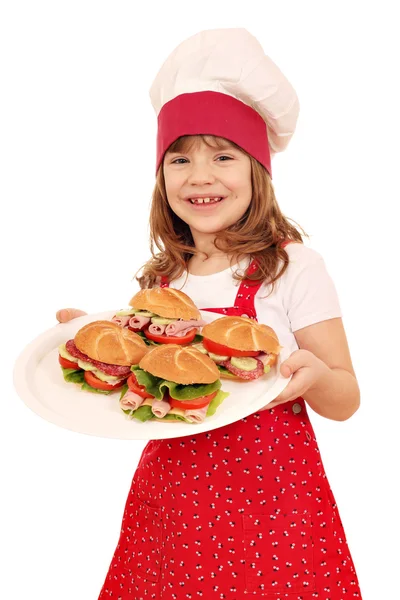 Happy little girl cook hold plate with sandwiches — Stock Photo, Image