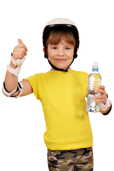 Happy little girl with roller skates equipment and thumb up — Stock Photo, Image