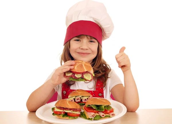 Heureuse petite fille cuisinier avec sandwich et pouce vers le haut — Photo