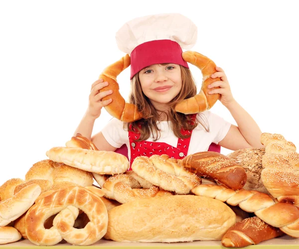 Happy little girl cook with breads and rolls — Stock Photo, Image