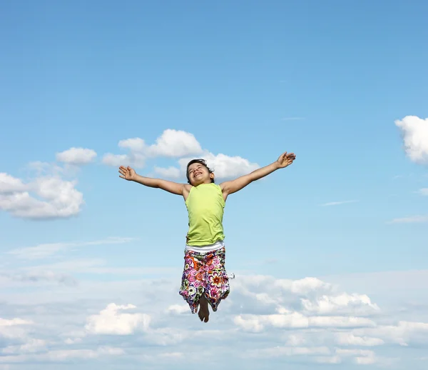 Happy little girl flying in the sky — Stock Photo, Image