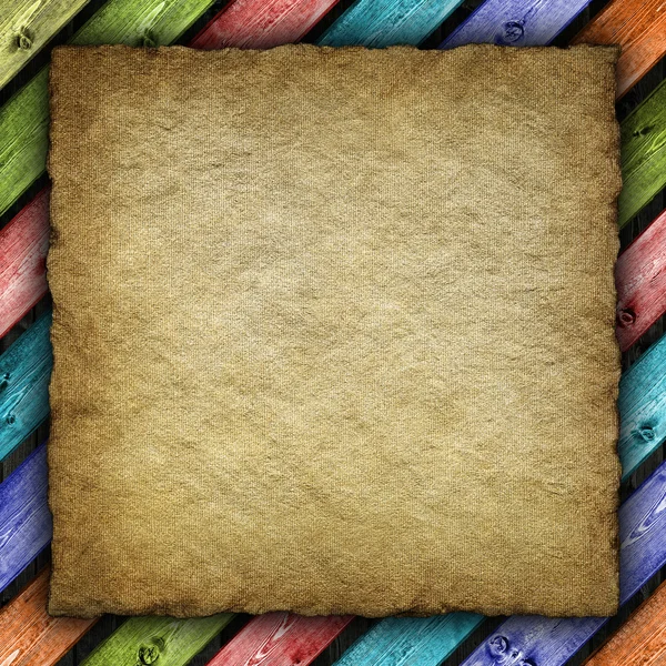 Old handmade paper or canvas sheet on colored background — Stock Photo, Image