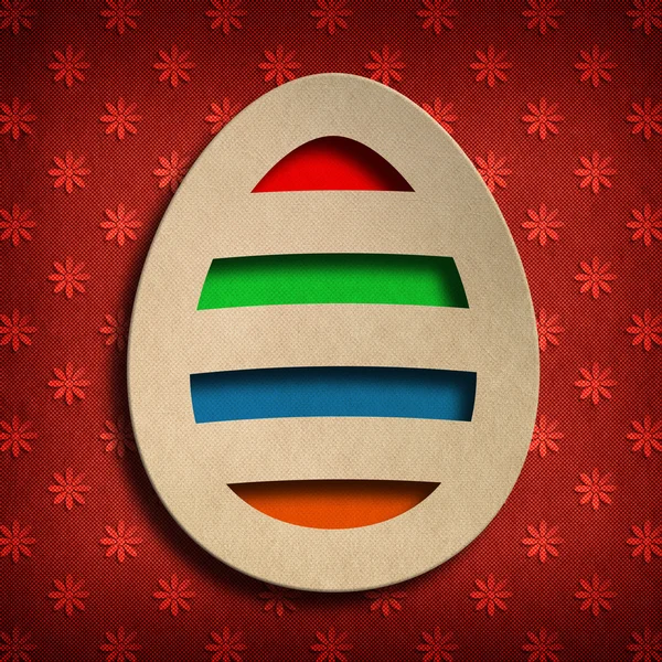 Colored Easter egg on red patterned background — Stock Photo, Image