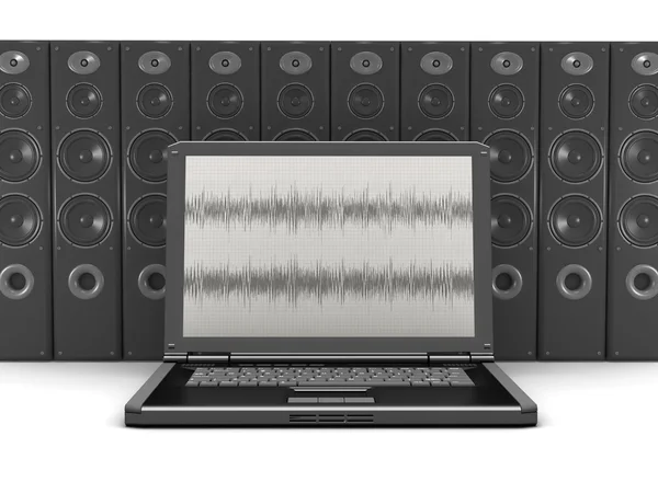 Laptop computer and many audio speakers in background — Stock Photo, Image