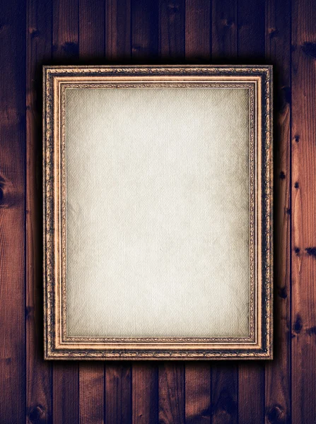 Picture frame on wooden background — Stock Photo, Image