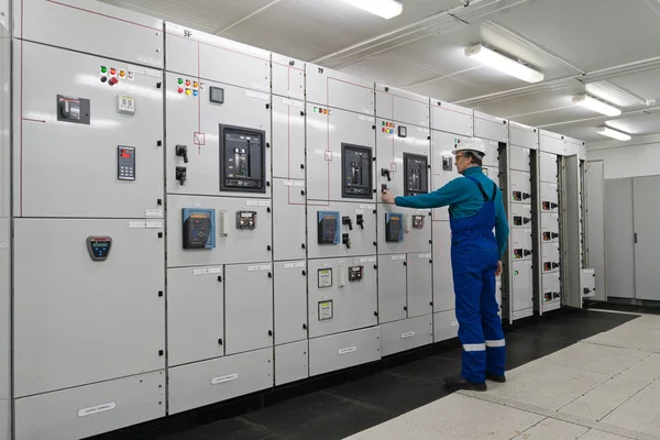 Man is in electrical energy distribution substation — Stock Photo, Image