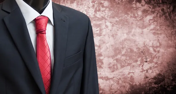 Man in suit on a concrete wall background — Stock Photo, Image