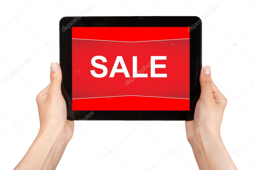 hands holding a tablet with sale on a red screen