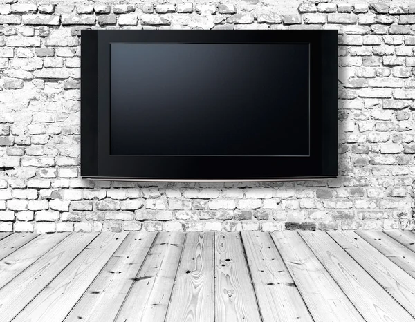 Televisie op een oude muur — Stockfoto