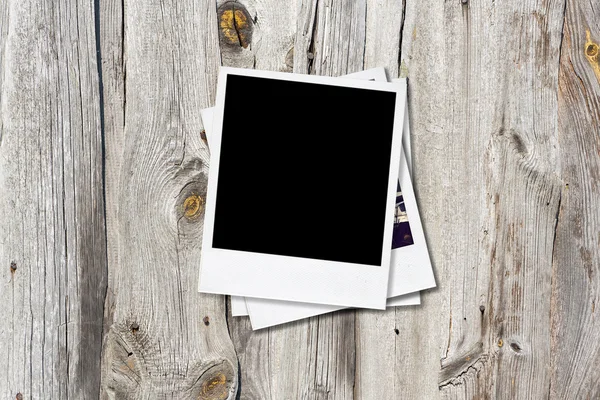 Blank photo frames on old wooden background. — Stock Photo, Image