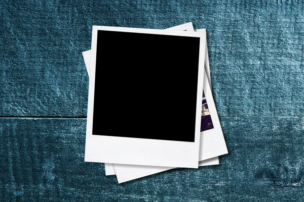 Blank photo frames on old wooden background. — Stock Photo, Image