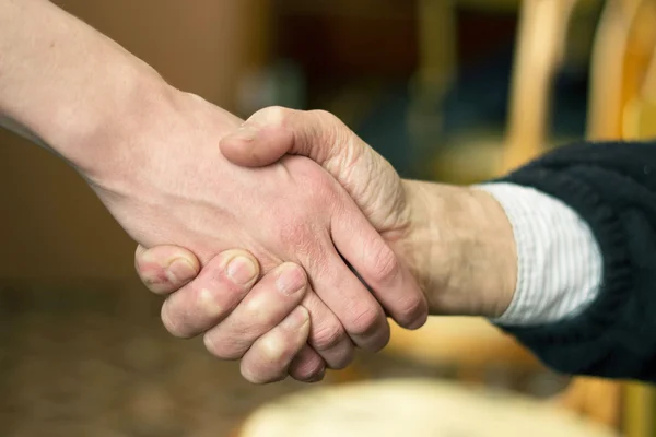 Two hands in a handshake — Stock Photo, Image