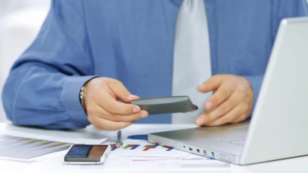 Businessman using calculator and laptop computer — Stock Video