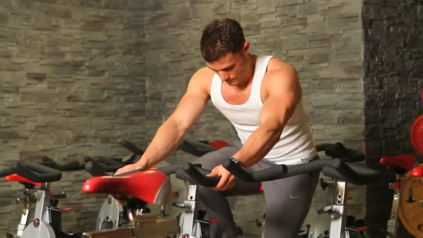 Handsome sporty man is exercising in gym centre — Stock Video