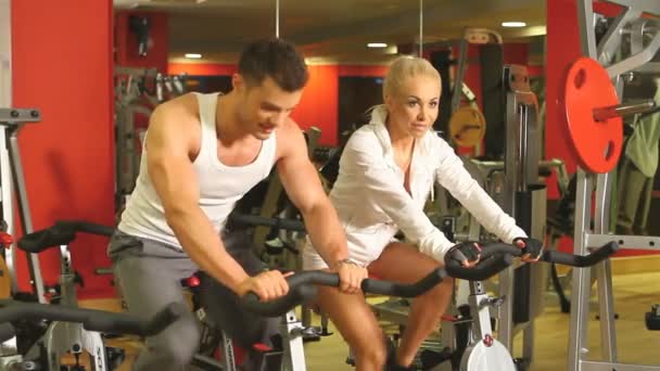 Sporty couple are exercising at gym centre — Stock Video