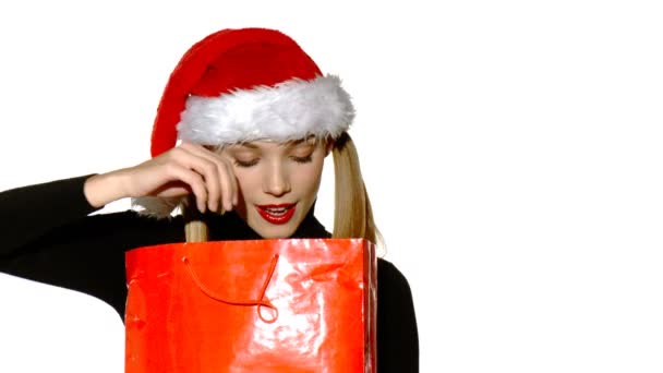 Sexy chica en Santa Claus sombrero con bolsa llena de regalos — Vídeo de stock