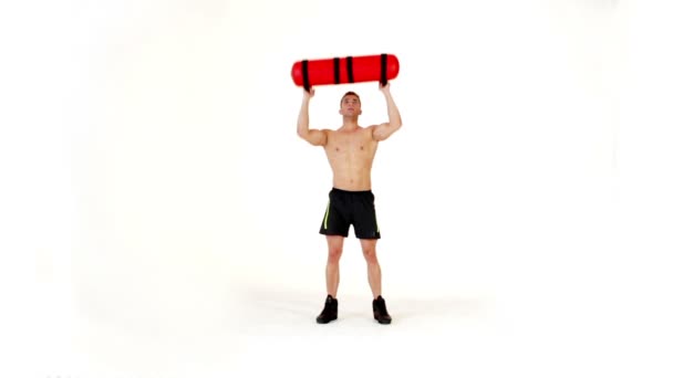 Hombre musculoso guapo haciendo ejercicio con bolsa de agua en blanco — Vídeos de Stock