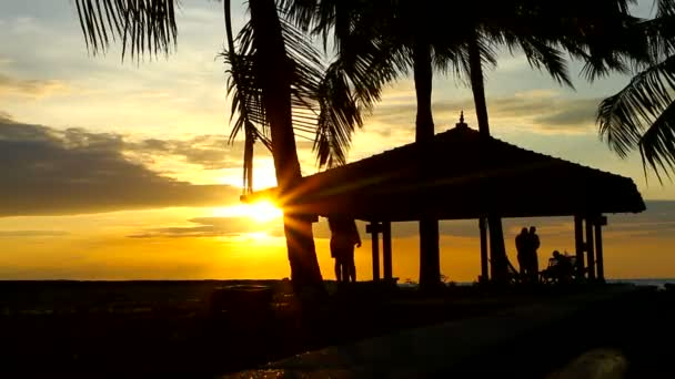 Walking at sunset, next to water house — Stock Video