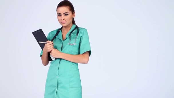 Young beautiful female doctor on white background — Stock Video