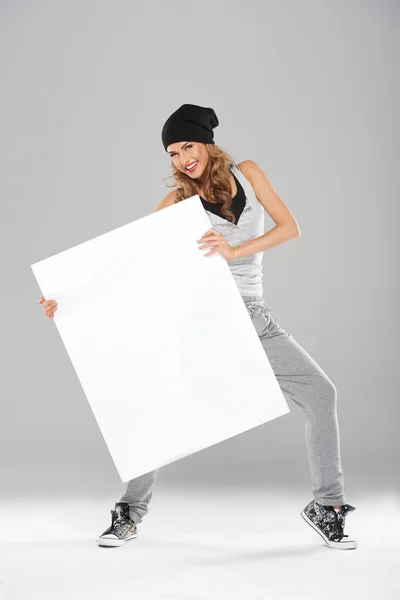 Young fashionable modern dancer holding empty board — Stock Photo, Image