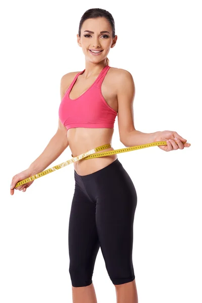 Happy slim woman measuring her waist — Stock Photo, Image