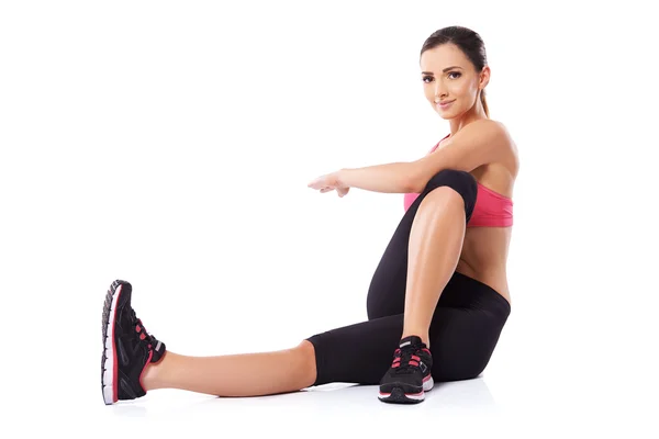 Woman doing body twist exercises — Stock Photo, Image