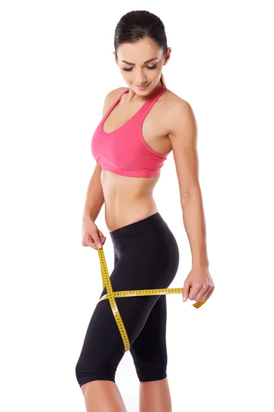 Shapely woman measuring her thigh — Stock Image Shapely woman measuring her thigh Royalty Free Stock Photos
