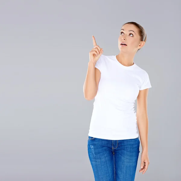 Woman looking up and pointing — Stock Photo, Image