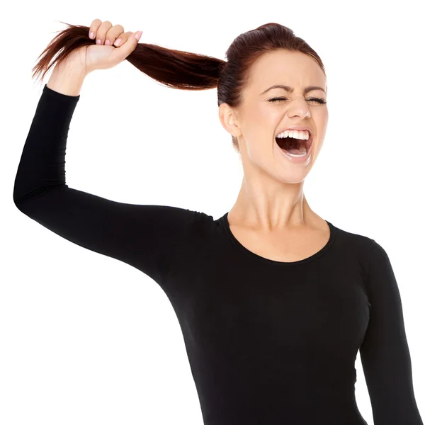Woman fed up with long hair screaming — Stock Photo, Image