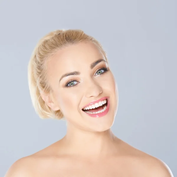 Glad blond kvinna med ett strålande toothy leende — Stockfoto