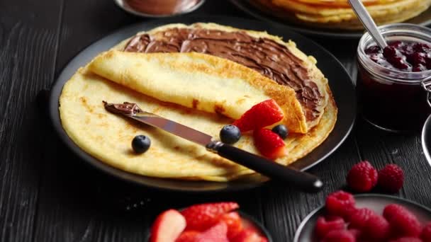 Delicious chocolate homemade pancakes on black ceramic plate — Stock Video