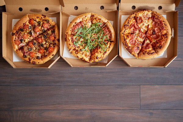 Three different kind of pizzas in delivery boxes Royalty Free Stock Photos