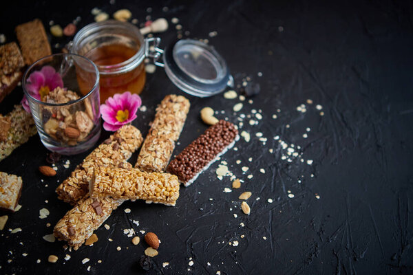 Healthy superfood composition. Various kinds granola energy protein bars with honey in jar Stock Picture