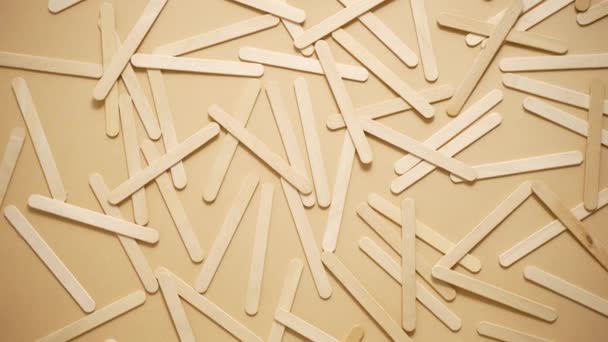 Wooden Popsicle Sticks Scattered Top Beige Background Flat Lay — Vídeo de Stock
