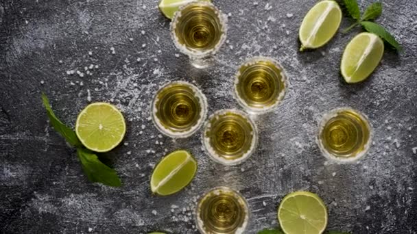 Top View Golden Tequila Shots Served Lime Sea Salt Table — ストック動画