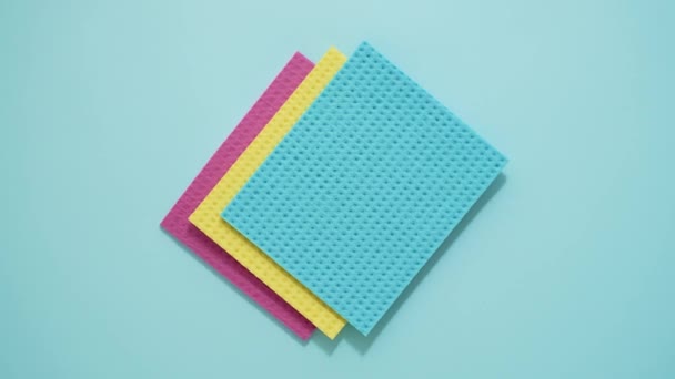 Colorful Kitchen Sponge Cloths Cleaning Essential Concept Isolated Blue Background — Stockvideo