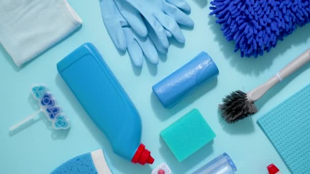 Colorful Cleaning Products Plain Blue Background Housecleaning Concept Top View — Stok video