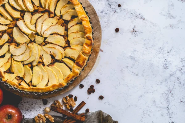 Fresh baked apple pie with fruits on a stone table. Top view, flat lay