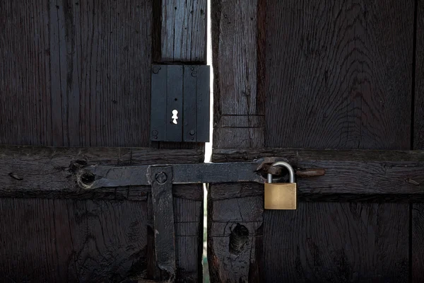 Black wooden door with a padlock — Stock Photo, Image
