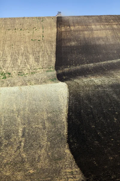 Tractor in plowed field — Stock Photo, Image