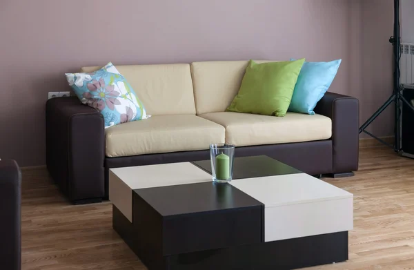 Sofa mit drei Kissen und Tisch — Stockfoto