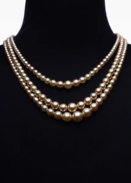 Yellow pearl necklace on black mannequin isolated on white — Stock Photo, Image