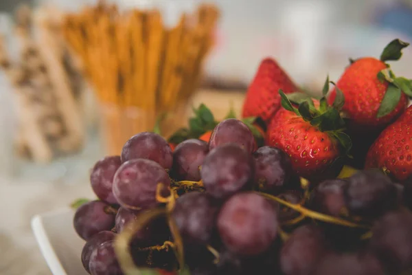 salty sticks and some sweet tubes in fornt of a bowl with fresh and healty food