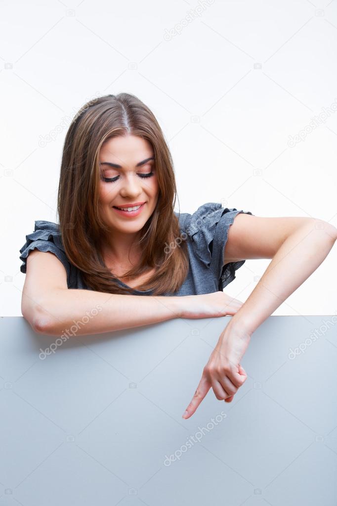 Woman leaning on big blank board